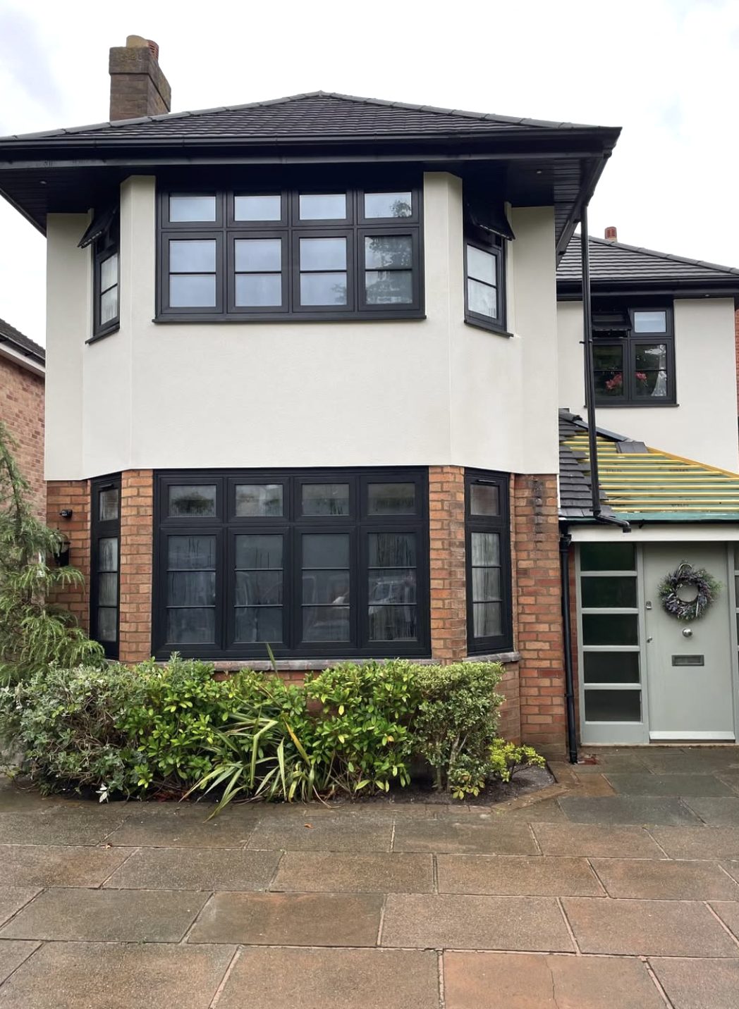 Semi with a rendered first-floor bay over a brick ground floor